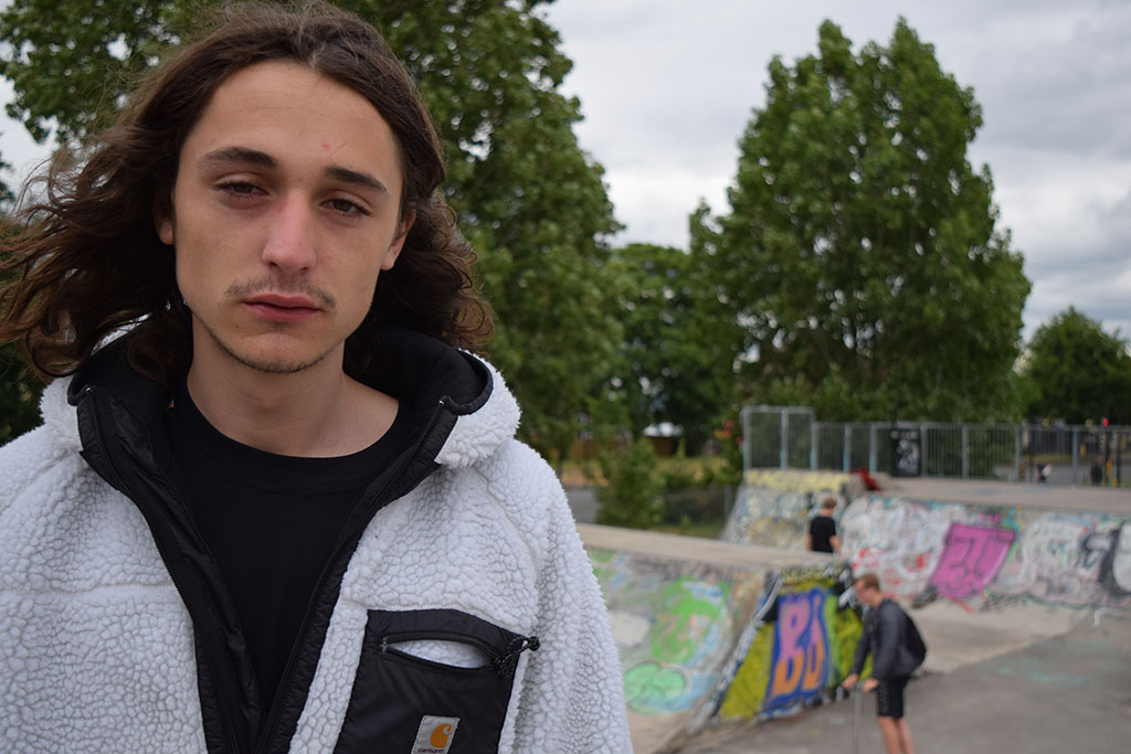 A headshot of chester with the skatepark in the background